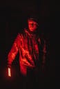 A Man in in Camouflage Jacket Holding a LED Red Light