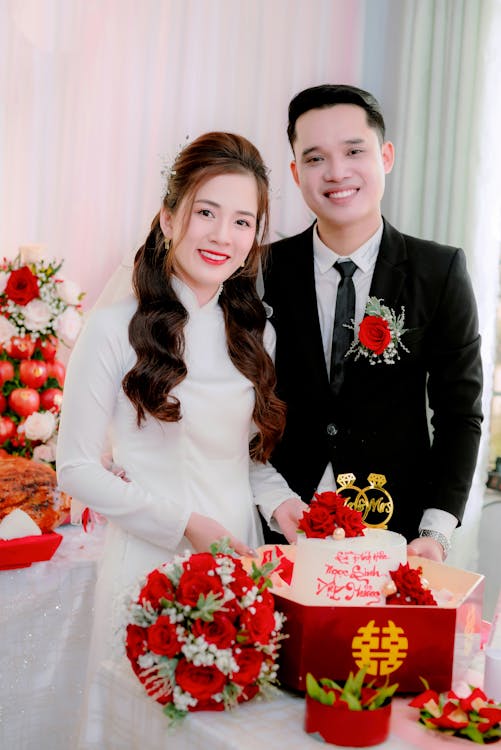 Wedding Couple Holding Their Cake · Free Stock Photo