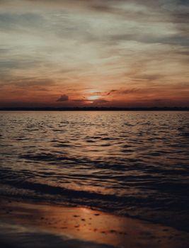 A beautiful sunset over the ocean, with golden sky reflecting on the calm water.