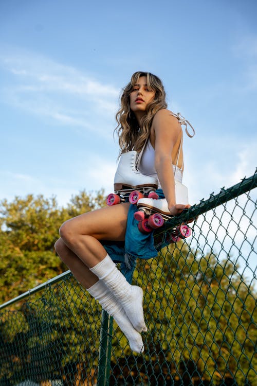 Woman in White Socks Sitting on Fence