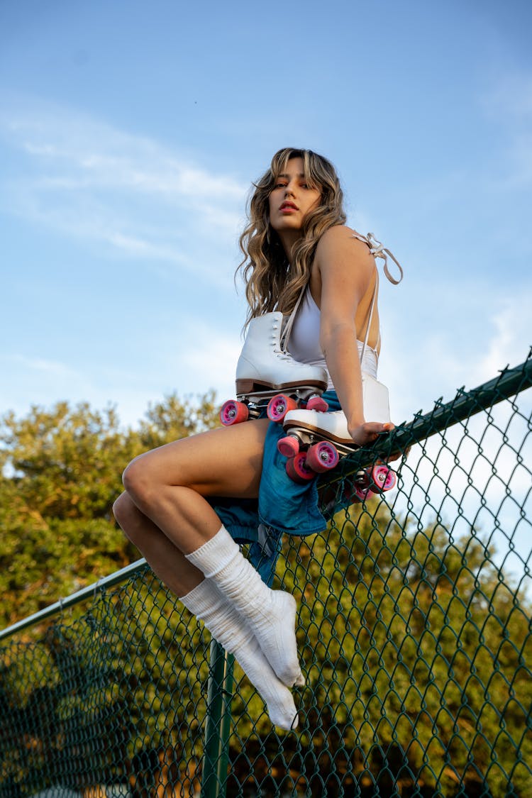 Woman In White Socks Sitting On Fence