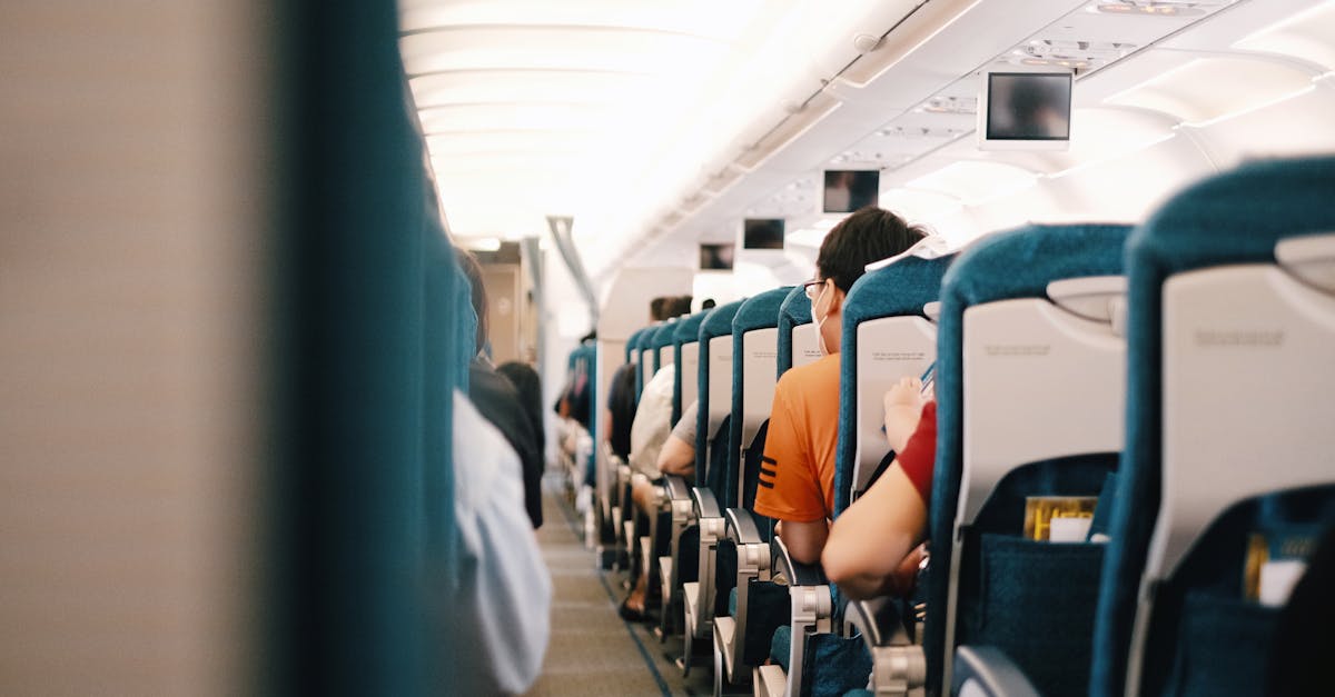 Manspreading On An Airplane Seat With Passengers Sitting Close Together