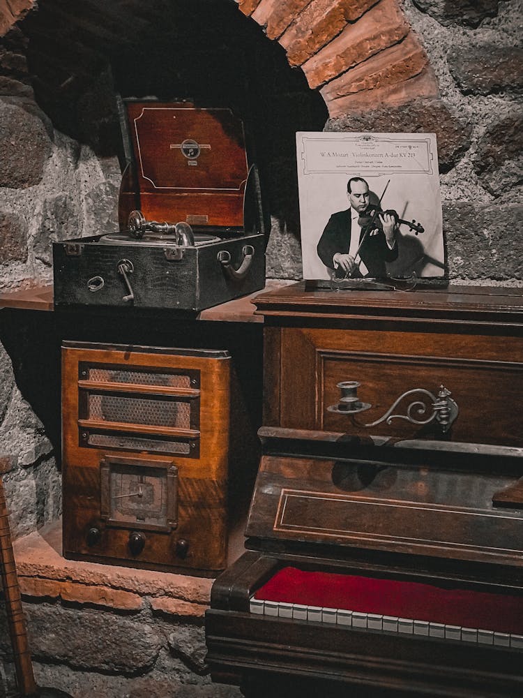 Photo Of An Antique Piano And A Radio 