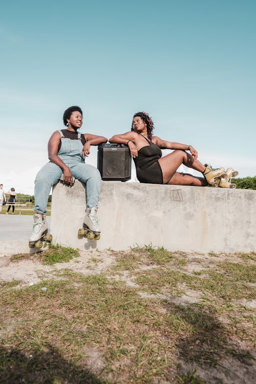 Women Sitting on Concrete Bench