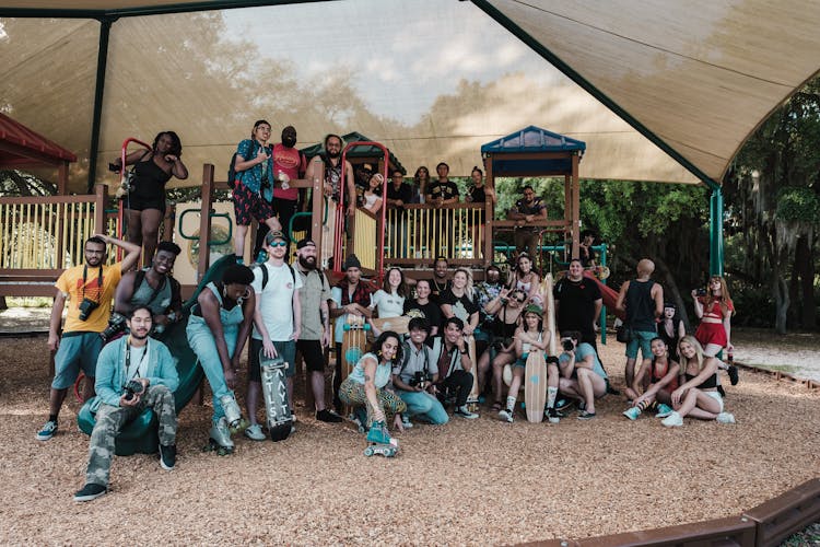 Group Of People Sitting In The Playground