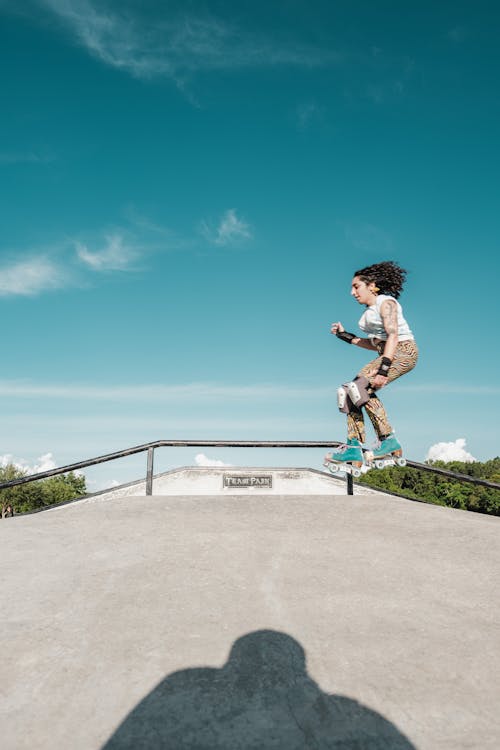 A Woman Roller Skating at the Skate Park