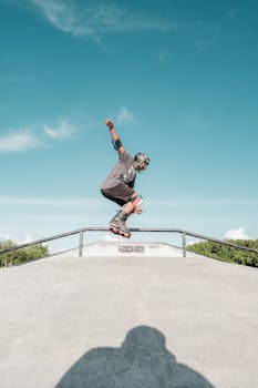 A skater skillfully grinding a rail at an outdoor skate park on a sunny day.