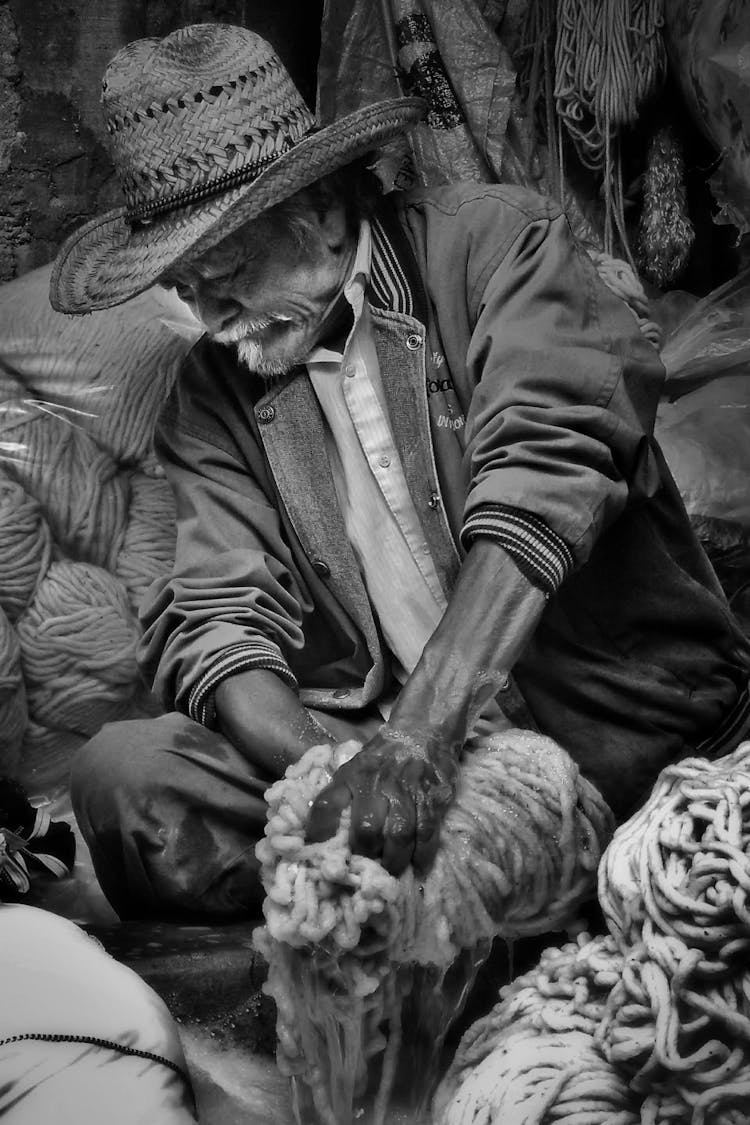 Elderly Man With Hat Holding String