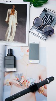 Explore a chic flat lay featuring modern tech gadgets and fashion accessories for a trendy lifestyle.