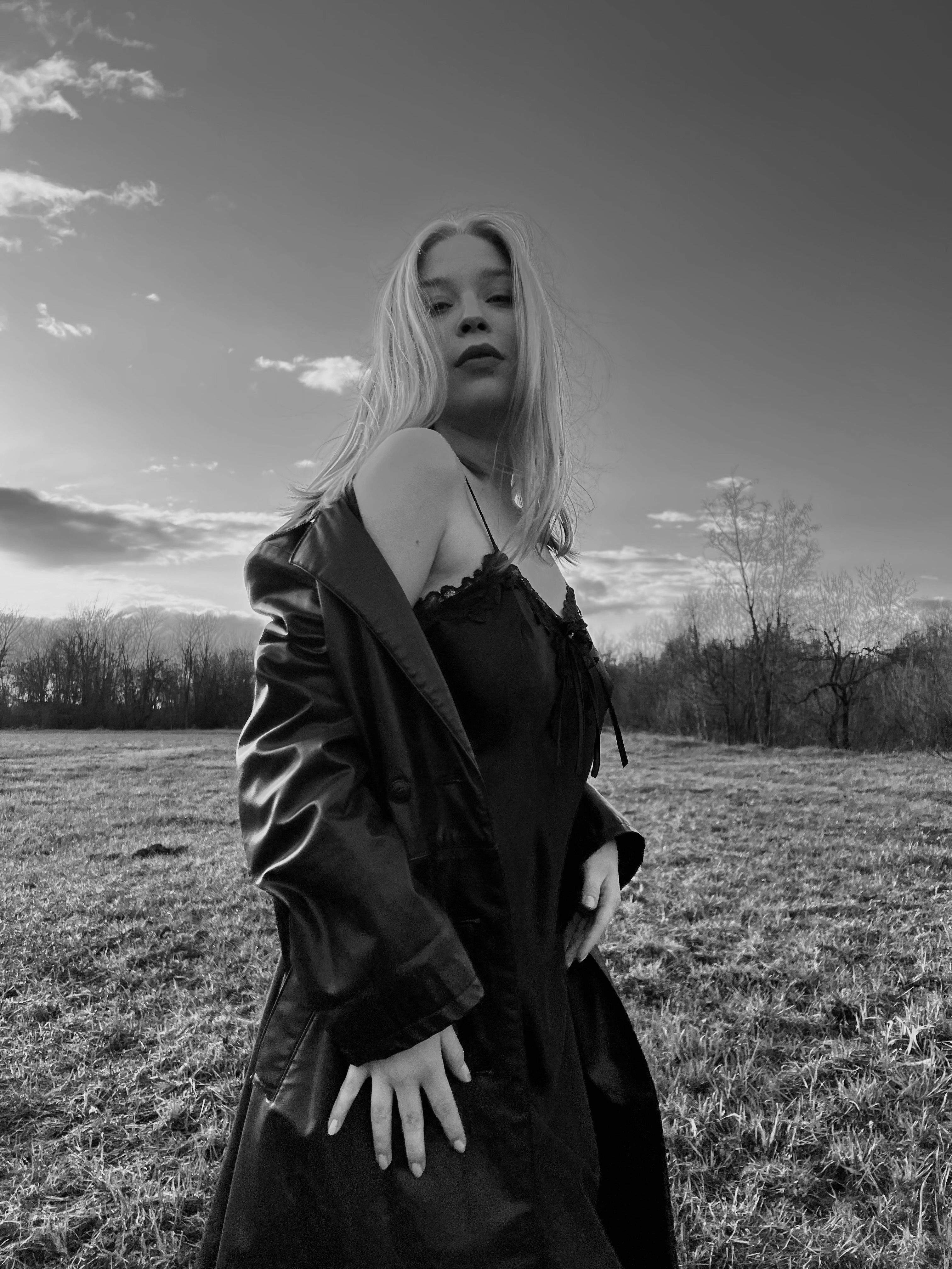 Grayscale Photo of a Woman in Black Dress Posing on a Grassy Field ...