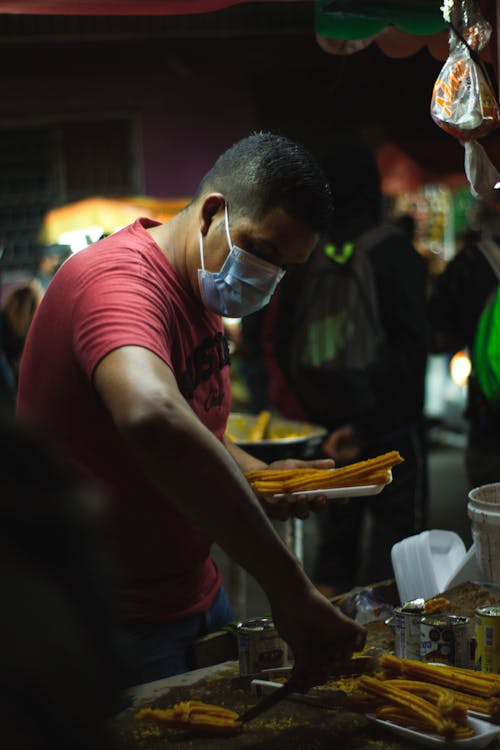 Man in Red Shirt Cooking Churros