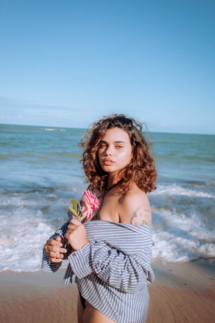 Woman With Flower On Beach