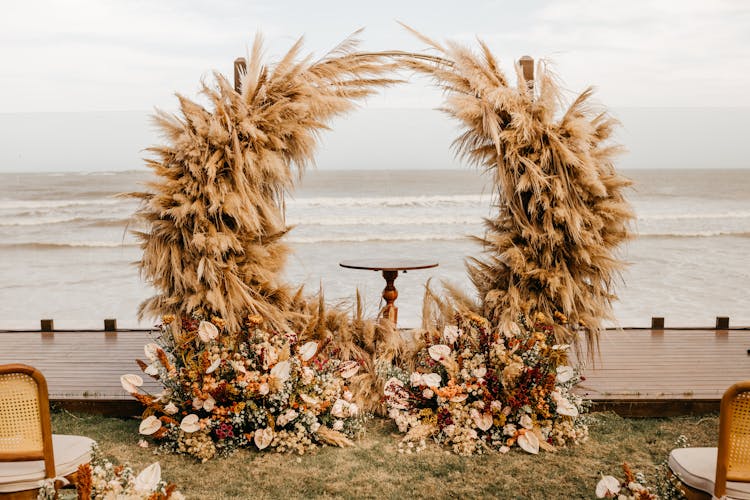 Wedding Arch With Flowers And Straw Decoration