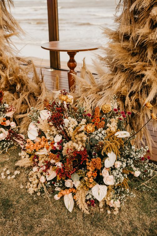 Free Stunning autumn floral display with rustic vibes by the beach, perfect for seasonal events. Stock Photo