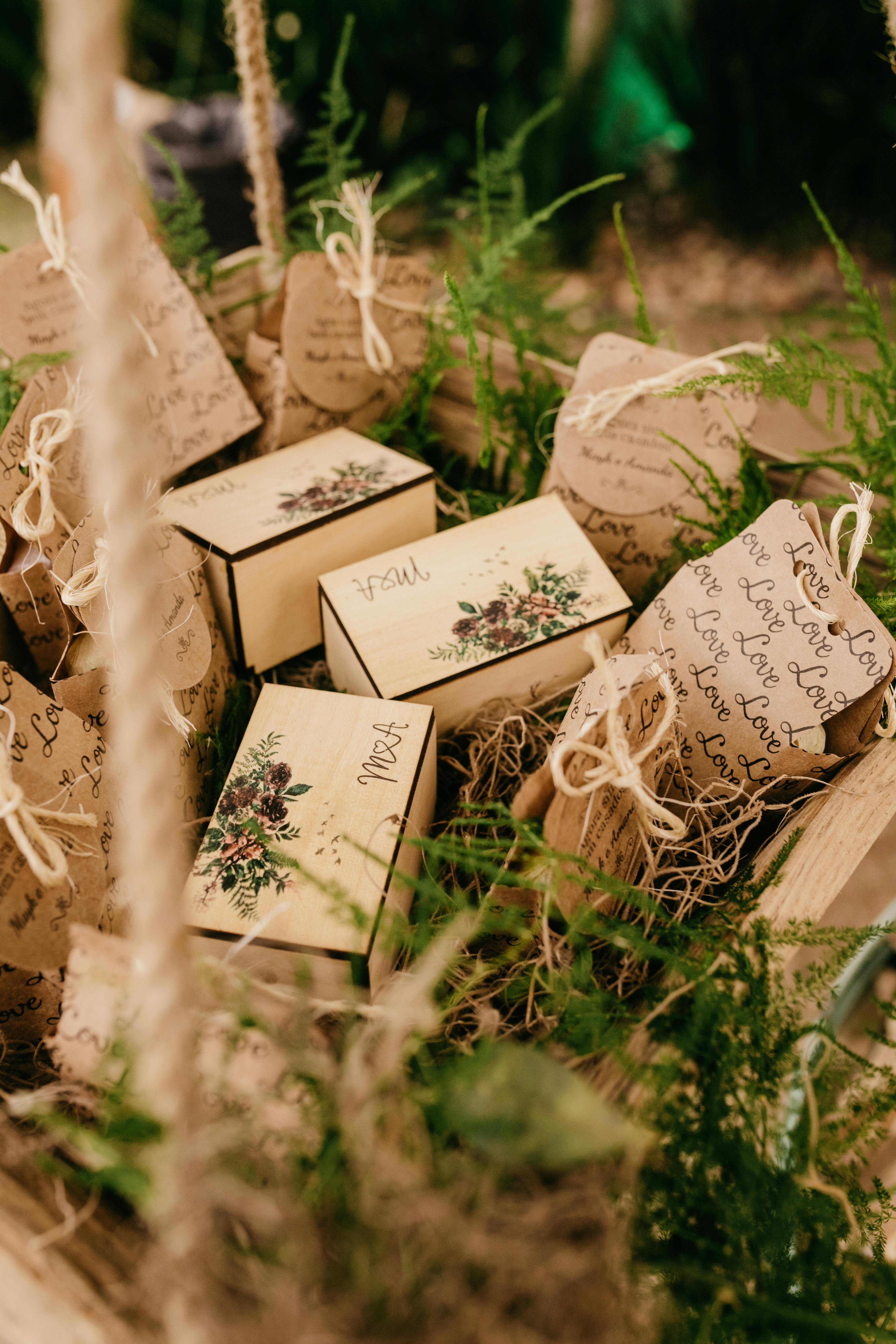 A collection of handmade rustic gift boxes with fern leaves, perfect for nature-themed occasions.
