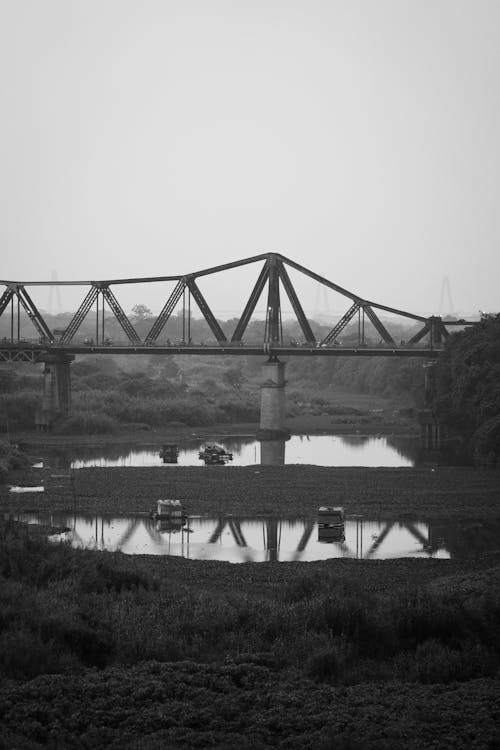 Grayscale Photo of a Bridge over the River