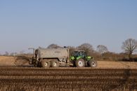Tractor delivering slurry onto a field