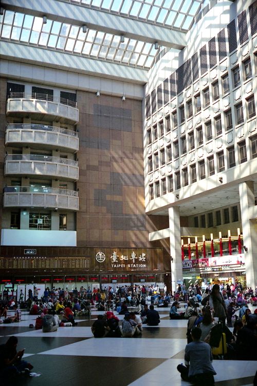 Free People gather at Taipei Main Station in Taiwan, showcasing vibrant travel atmosphere. Stock Photo