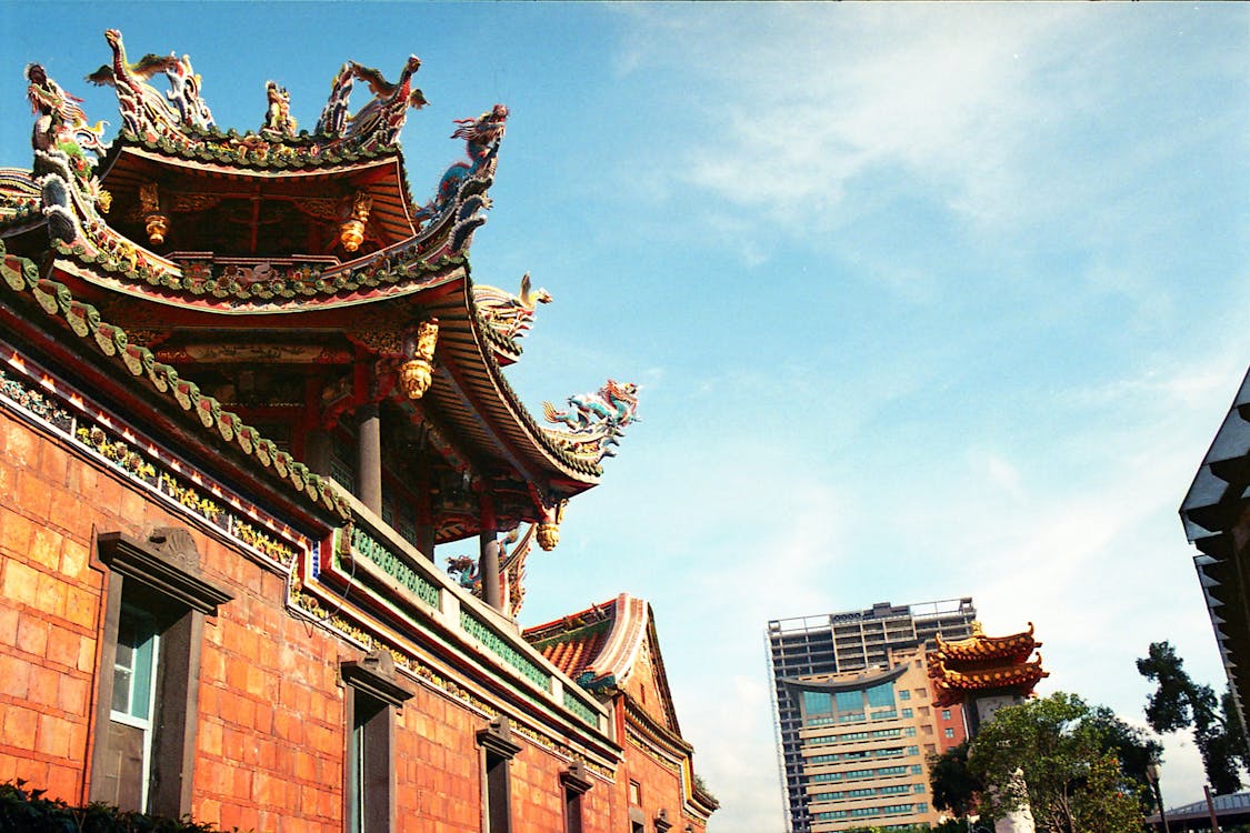 Facade of a Buddhist Temple with Statues on the Roof 