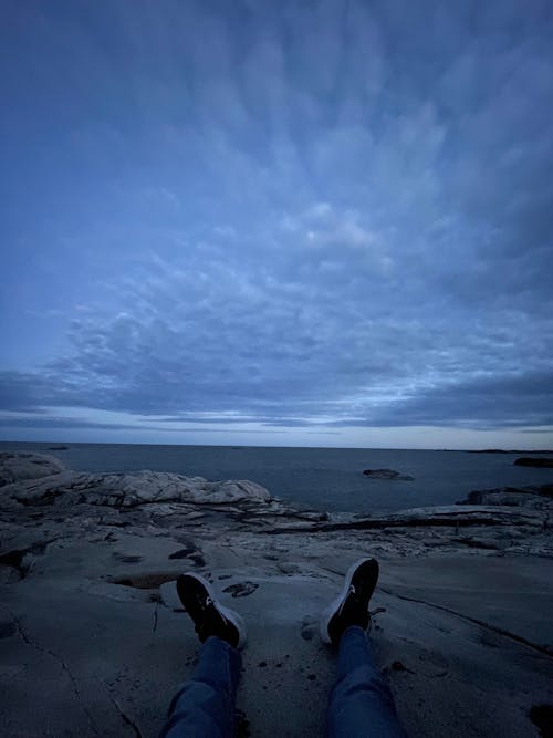 Free sitting by the shore evening Stock Photo