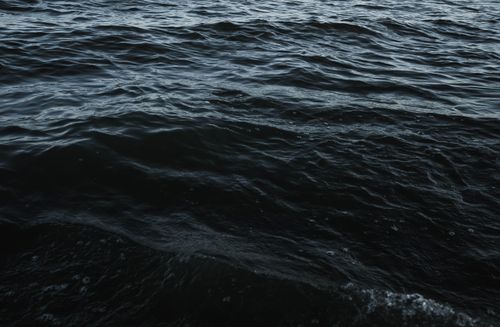 Free A close-up view of dark ocean waves showing texture and movement, captured at dusk. Stock Photo