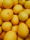 Yellow Round Fruits on White Ceramic Plate