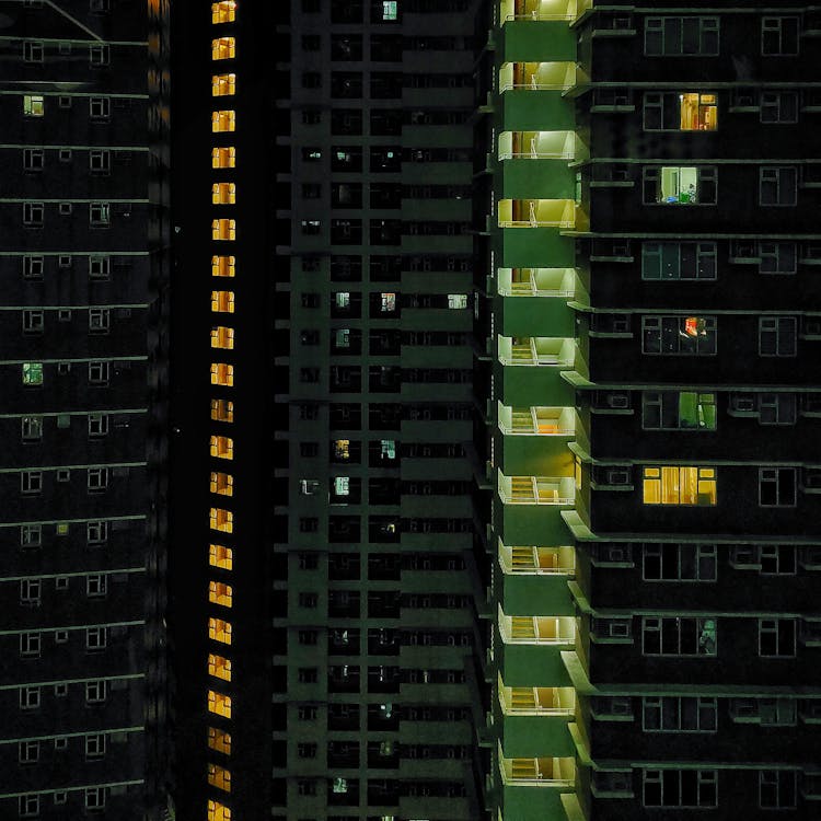 Tall Apartment Buildings With Lights At Night