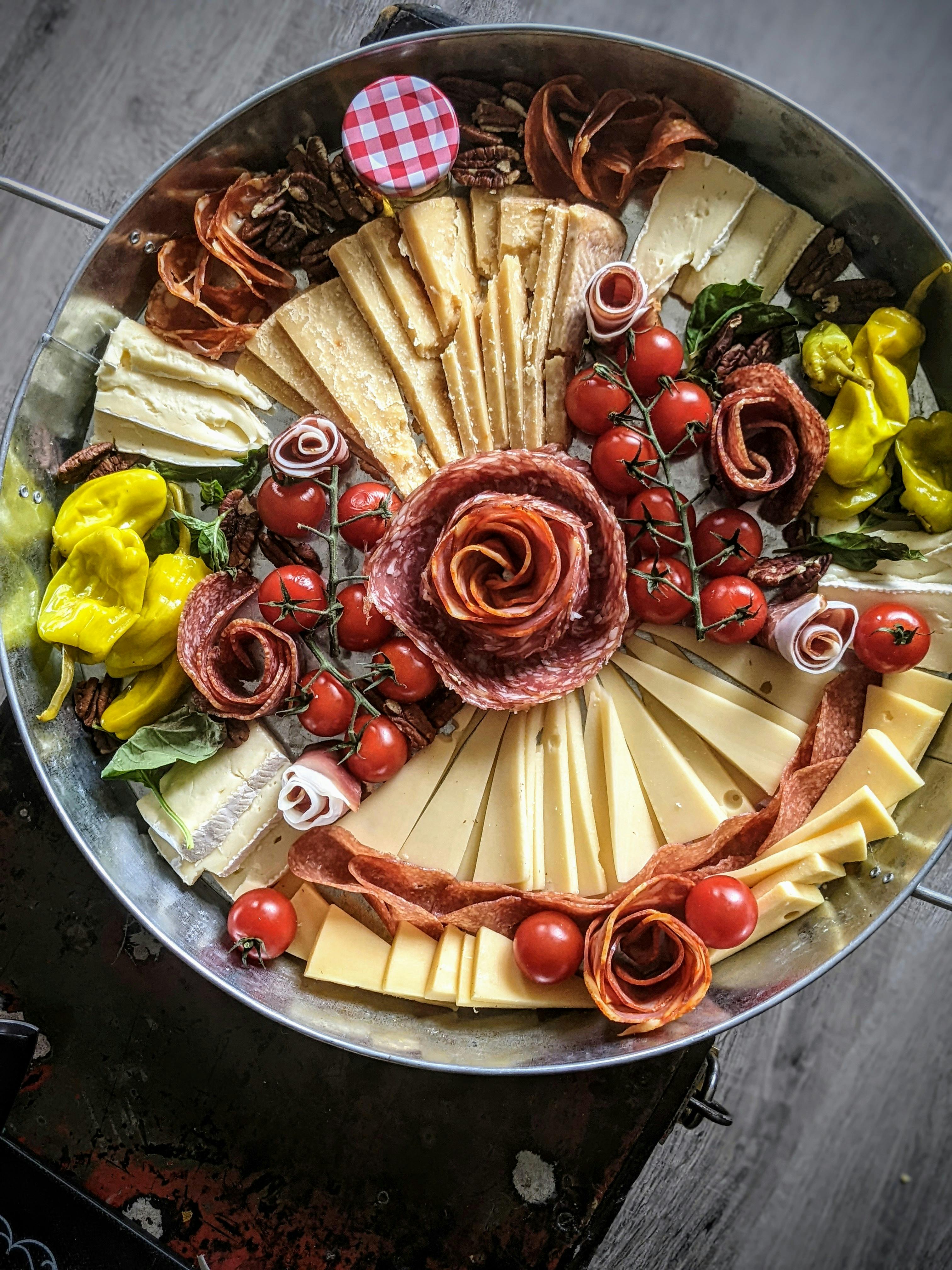Free A vibrant cheese and charcuterie platter arranged with fruits and meats, perfect for gatherings. Stock Photo