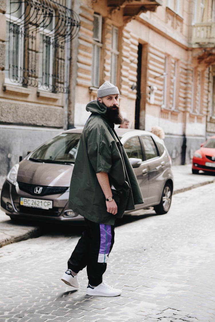 Man With A Long Beard Walking Through A Street Looking Over Shoulder 