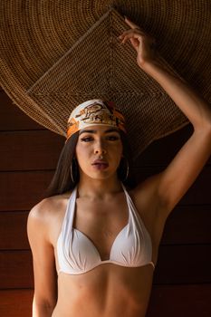 Portrait of a stylish woman posing in a bikini with a bandana in Caieiras, Brazil.