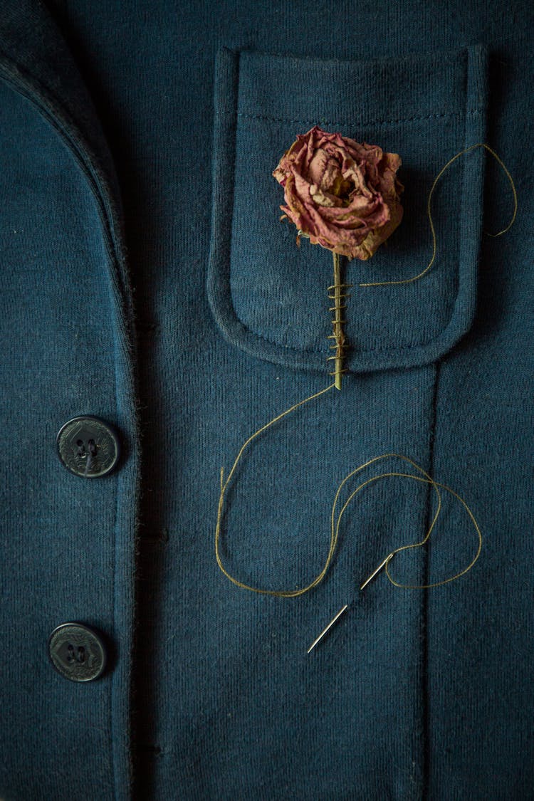 Dry Rose Sewn To The Pocket Of A Jacket 