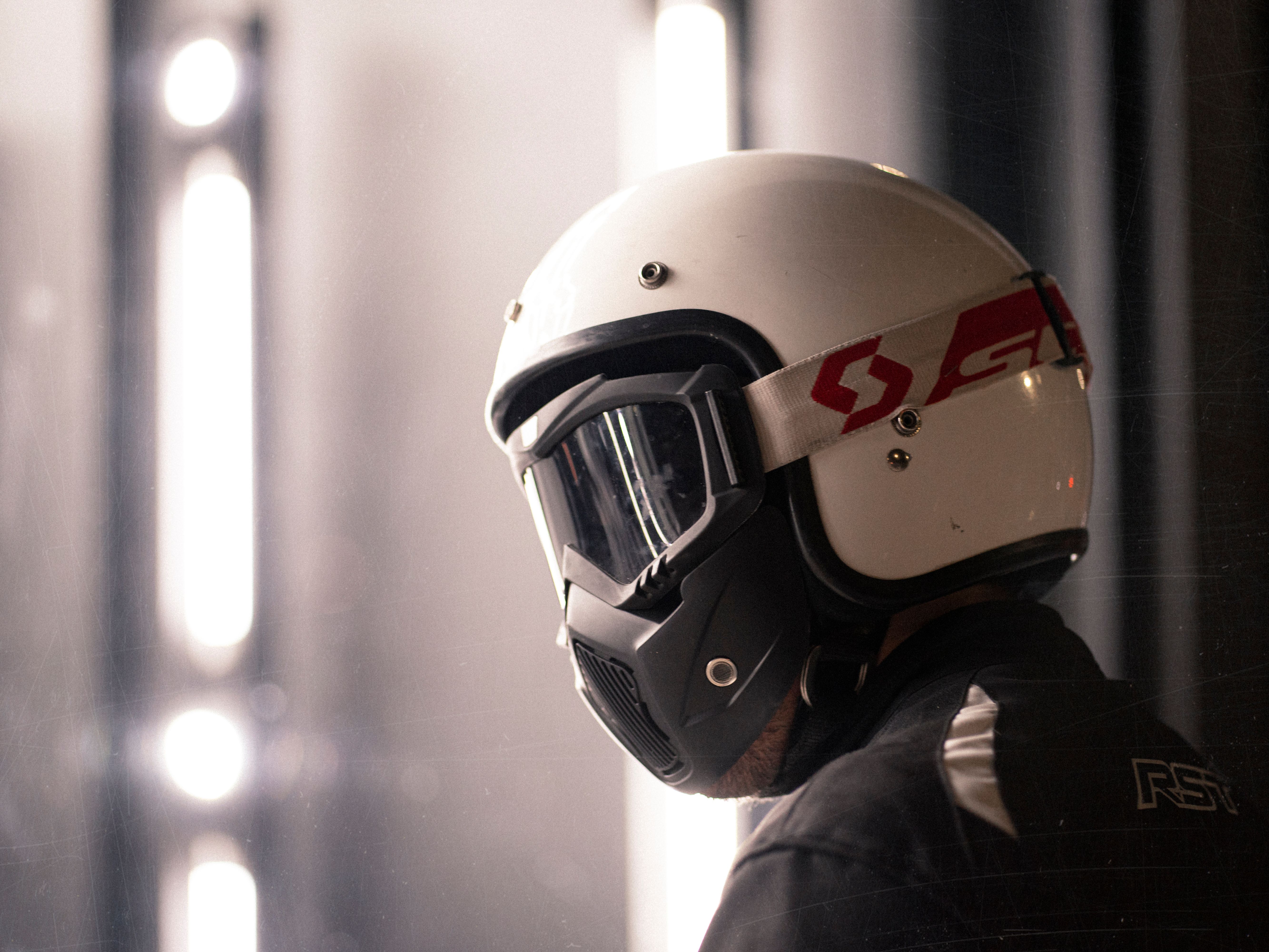 Close-up of a protective motorcycle helmet with goggles, side view.