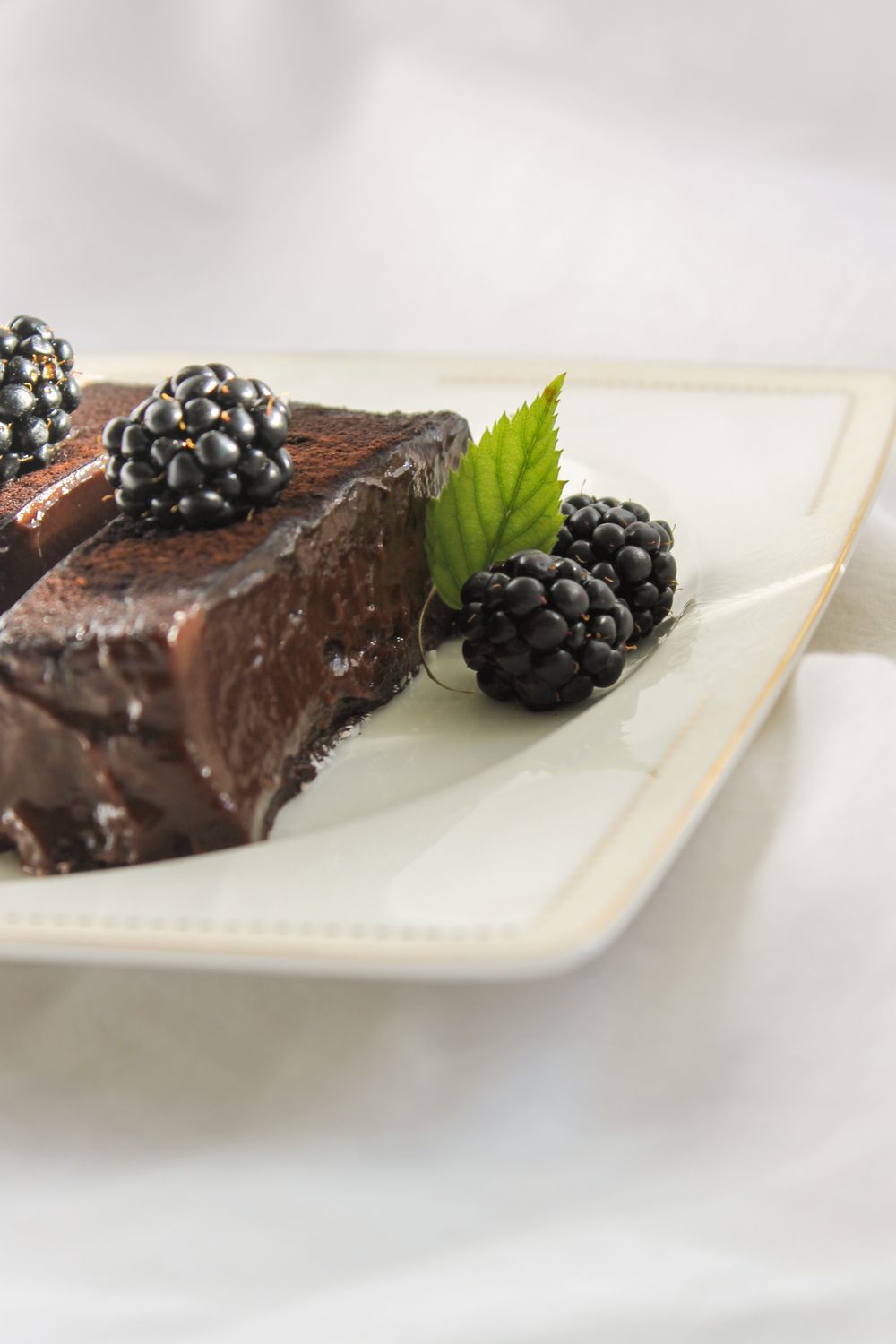 Blackberries on a Plate by a Piece of Chocolate Cake · Free Stock Photo