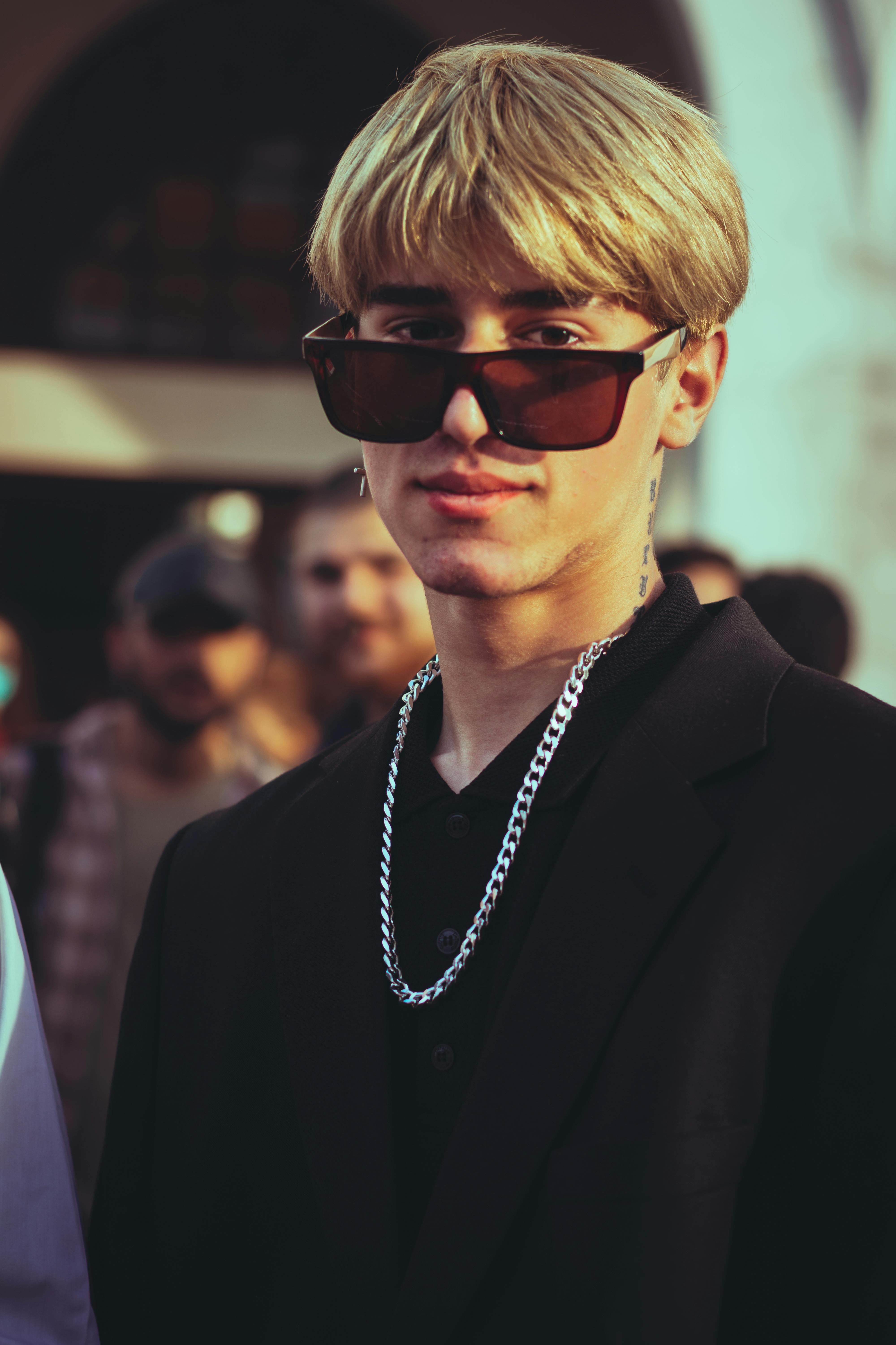 a man in black suit jacket wearing black sunglasses