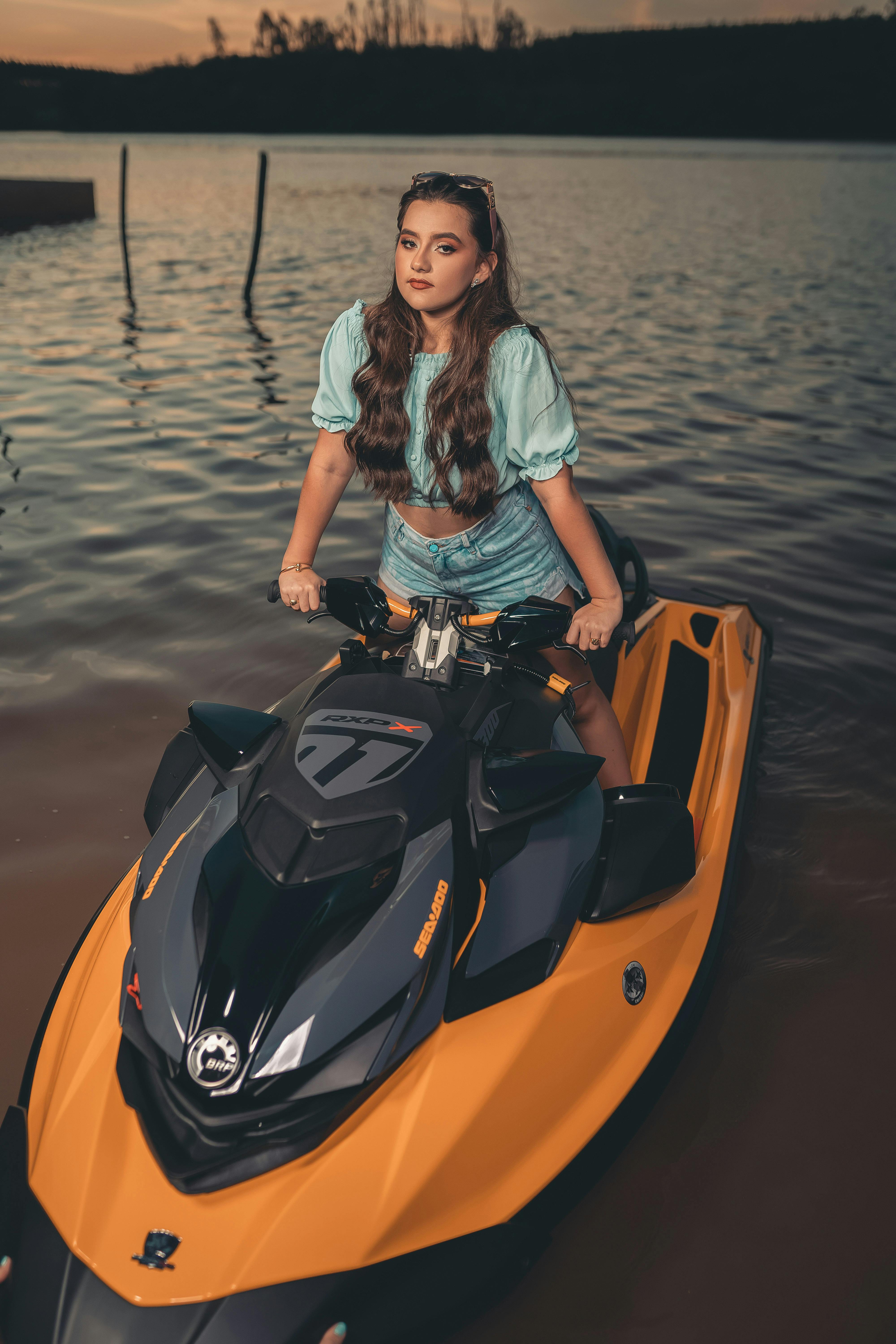 A Woman in Denim Shorts Riding a Jetski · Free Stock Photo