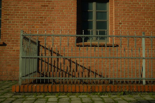 Black Railings Beside the Brick Building