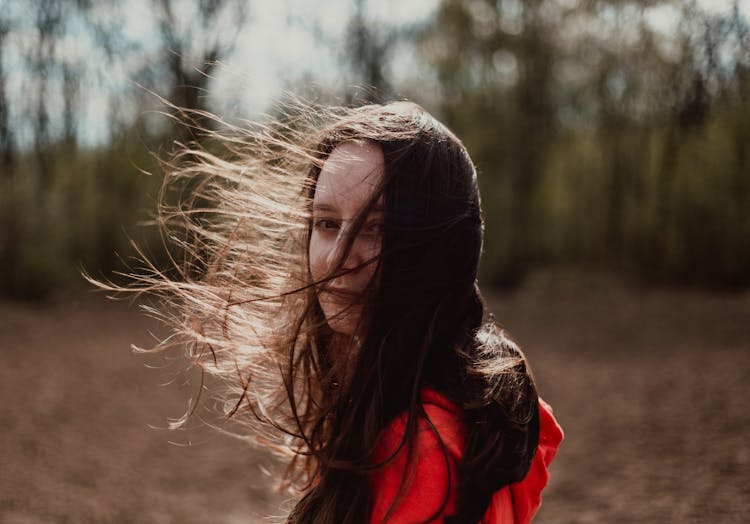 A Woman With Hair Blown By The Wind 