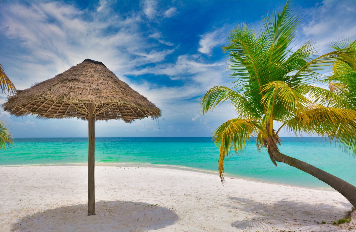 Palm-fringed white sand beach and turquoise water on Koh Rong