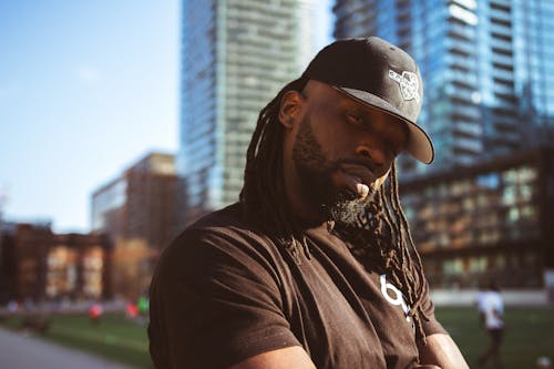 Free A Man in Black Shirt Wearing a Black Hat Stock Photo