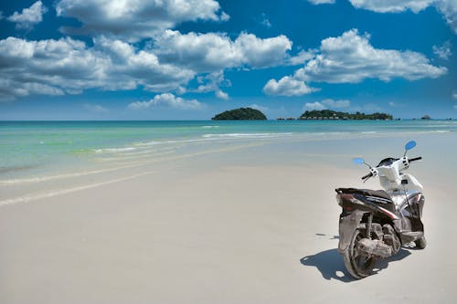 Free motorbike on a white tropical sandy beach Stock Photo