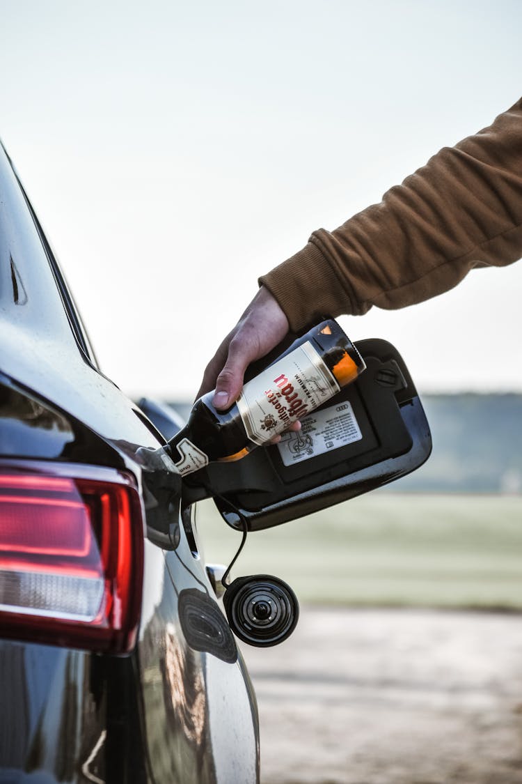 Pouring Alcohol Into Car Tank