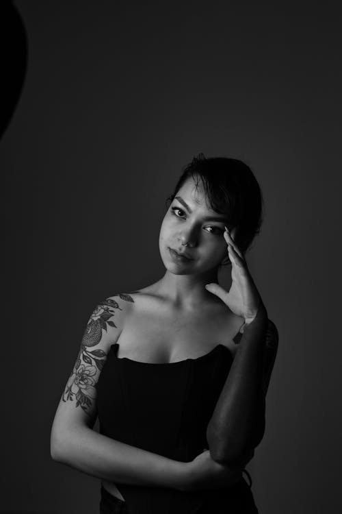 Free A Woman in Black Tube Top with Her Hand on Her Head Stock Photo