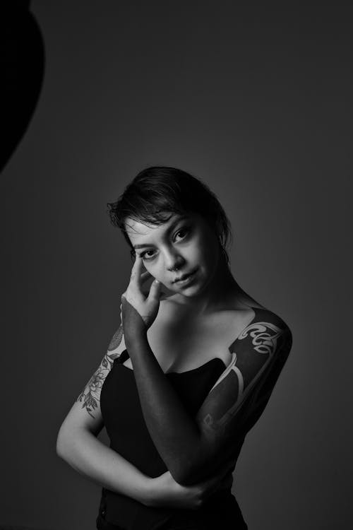 Free A Grayscale Photo of a Tattooed Woman in Black Tube Top Stock Photo