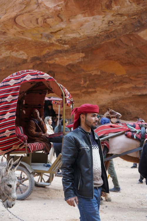 People Walking and Riding in Carriage near Rock Formation