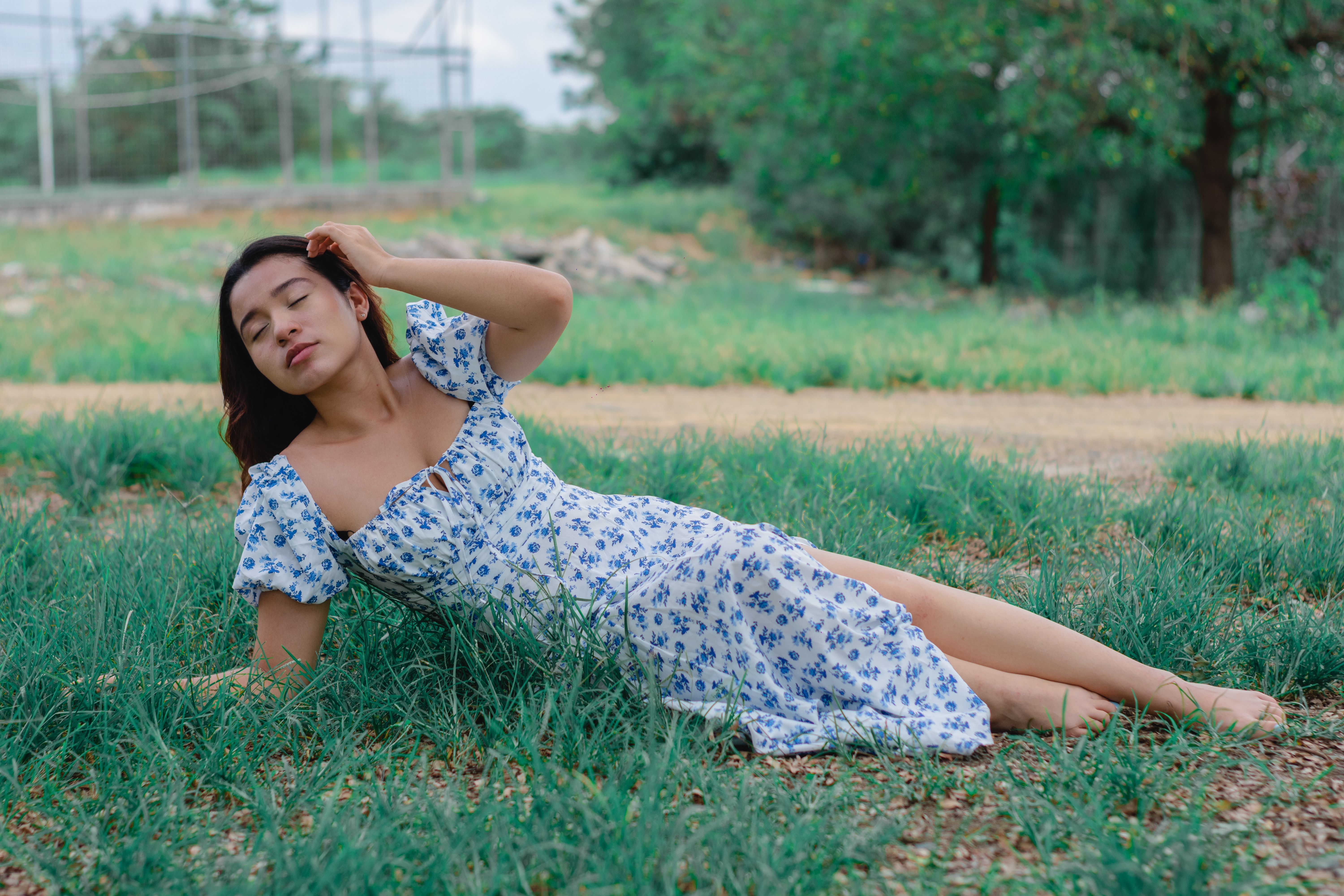 Two Women in White Dress Lying on Brown Grass Field · Free Stock Photo