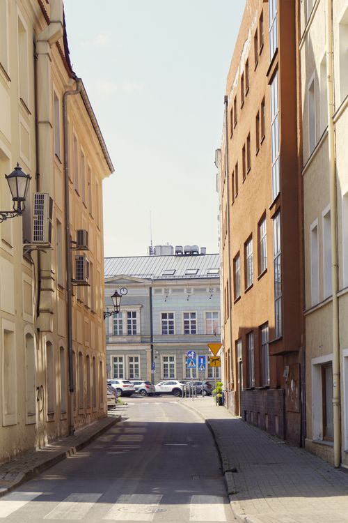 Free A scenic alley in Zielona Góra, Poland, showcasing classic architecture under a bright sky. Stock Photo