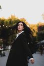 Attractive Woman in Black Coat Turning Back
