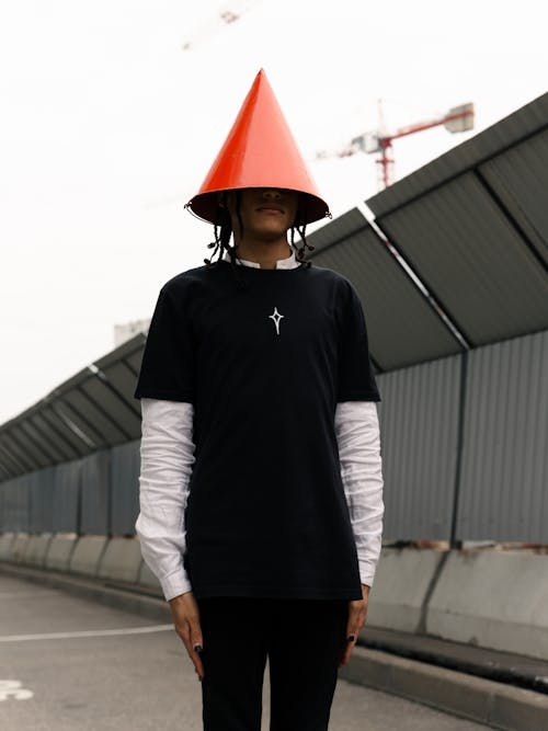 Portrait Of a Man With Dreadlocks Wearing a Red Cone Hat