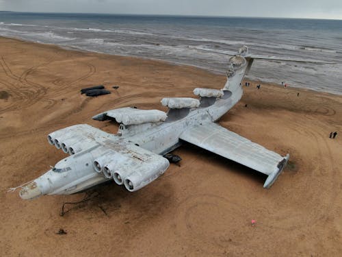 Free Abandoned Military Plane on Beach Stock Photo