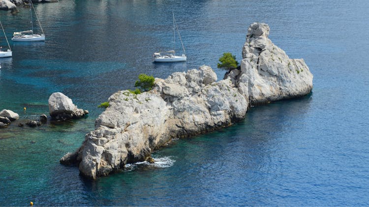 Rock Formation And Recreational Boats On A Lake